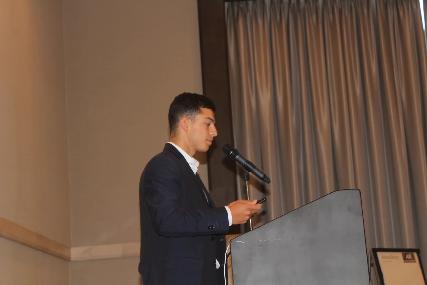 Student speaking at a VocationX event podium